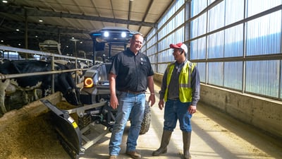 electric tractor and operators at dairy farm